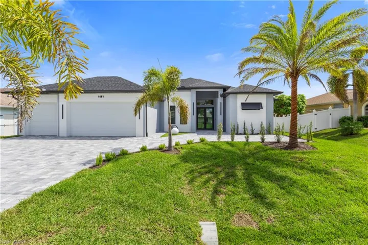 View of front of house featuring stucco siding, an attached garage, decorative driveway, and roof with shingles