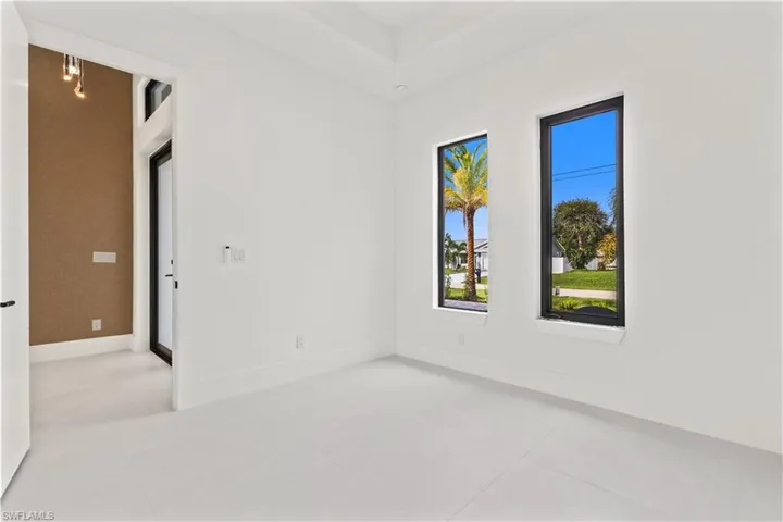 Empty room featuring baseboards and light tile patterned flooring