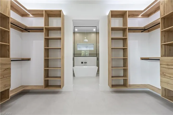 Spacious closet with light tile patterned floors
