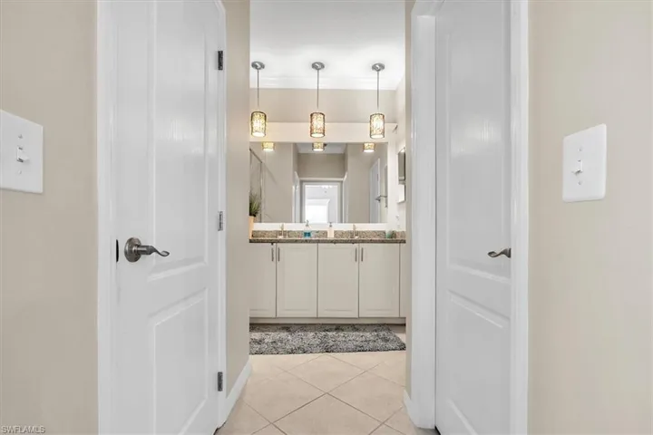 Double vanity featuring stone countertops and integrated sinks