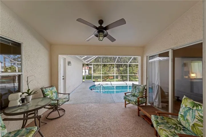 Screened lanai under truss overlooking pool