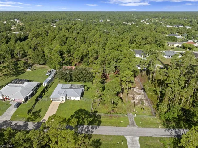 Enormous chain link fenced 1 acre yard space located on a dead end road with tons of mature trees and second gate access with driveway culvert