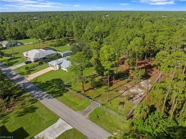 Enormous chain link fenced 1 acre yard space located on a dead end road with tons of mature trees and second gate access with driveway culvert