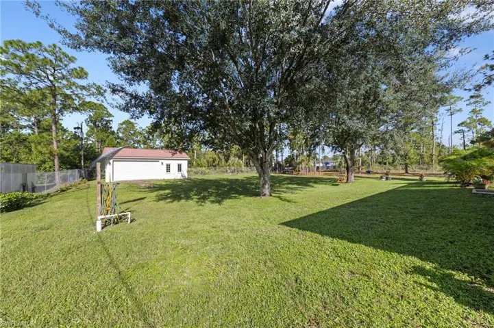 Enormous chain link fenced 1 acre yard space located on a dead end road with tons of mature trees and second gate access with driveway culvert