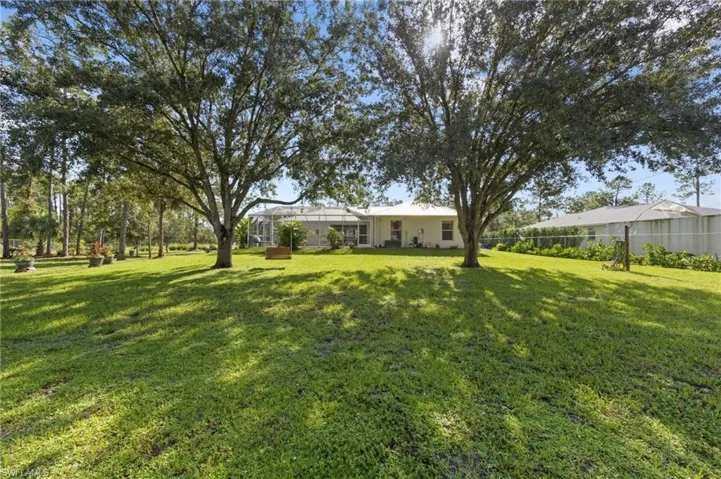 Enormous chain link fenced 1 acre yard space located on a dead end road with tons of mature trees and second gate access with driveway culvert