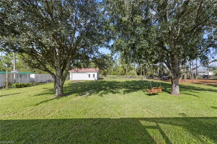 Enormous chain link fenced 1 acre yard space located on a dead end road with tons of mature trees and second gate access with driveway culvert