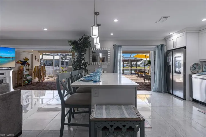 Dining space featuring marble finish floor, recessed lighting, crown molding