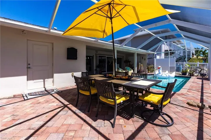 View of patio / terrace with screen enclosure, outdoor dining area, and pool