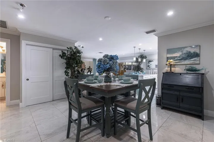 Dining space with recessed lighting, ornamental molding, baseboards, marble finish floor