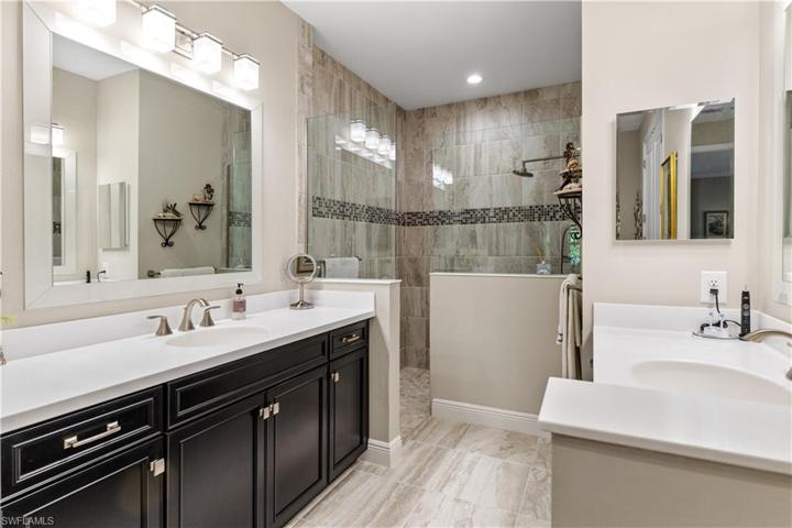 Primary Bathroom with double vanities, desinger mirror and lighting