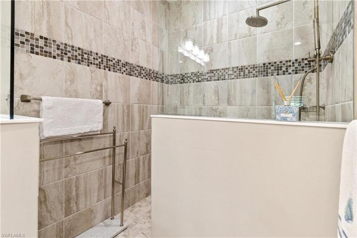 Large walk in shower with upgraded tile and fixtures