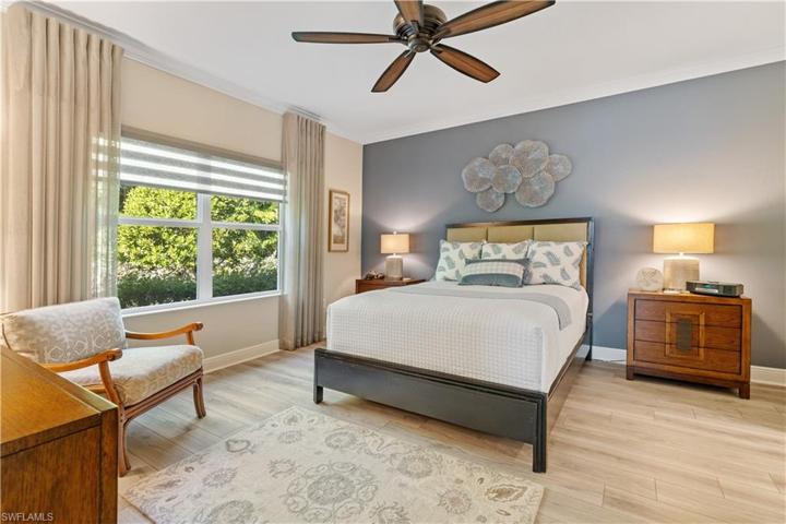 Spacious primary suite with crown molding, designer fan, window treatments and remote blind.  Large enough for a king bed.