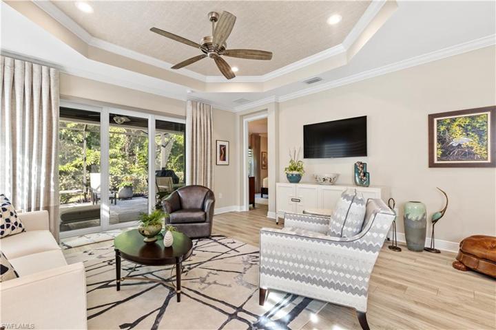 Coffered ceiling with recessed lighting, crown molding and designer fan with remote.  Mounted television is included