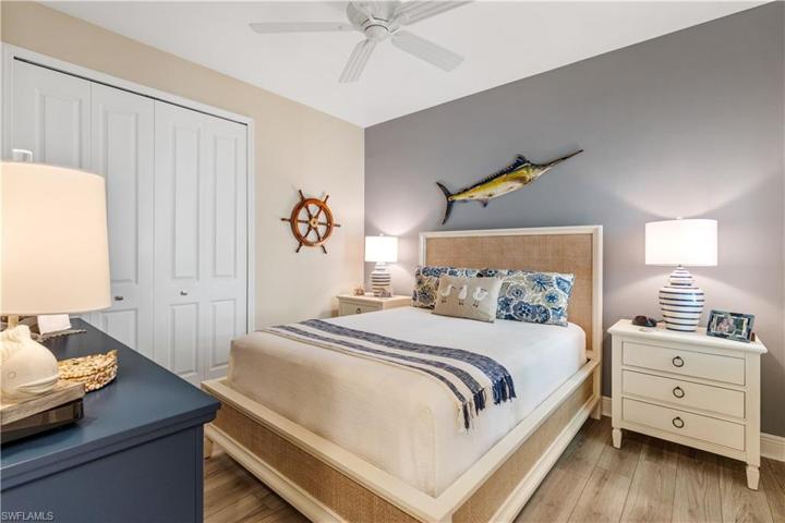 Guest bedroom with plantation shutters and custom closet