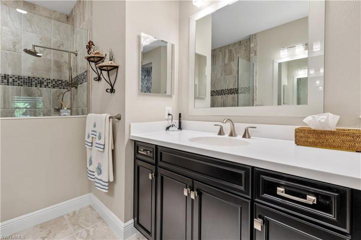 Vanity with Quartz countertops and wood cabinets