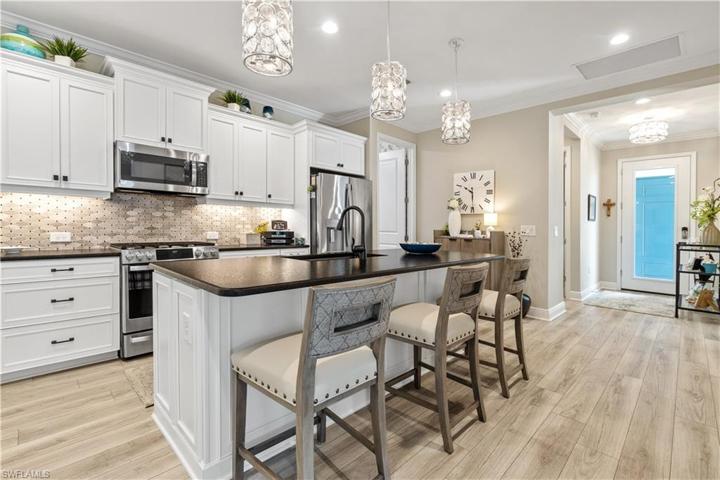 Kitchen has undercabinet lighting and breakfast bar