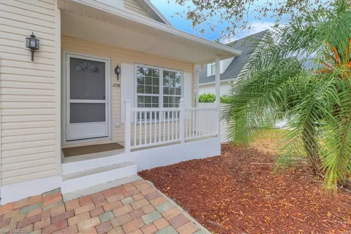 Entrance to property featuring covered porch
