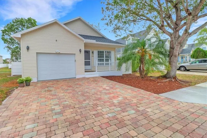 Single story home with brand new roof, paved driveway & garage