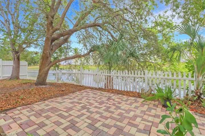 Large backyard oasis with fenced in yard, pavers and water view