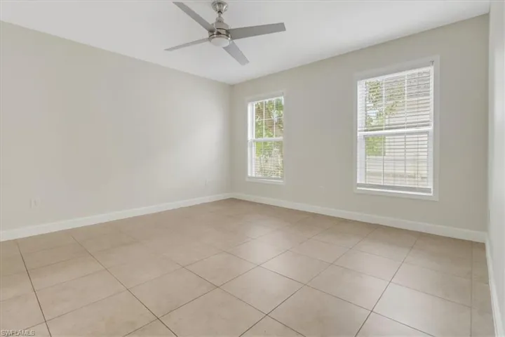 Bedroom with fresh paint & painted baseboards, and ceiling fan