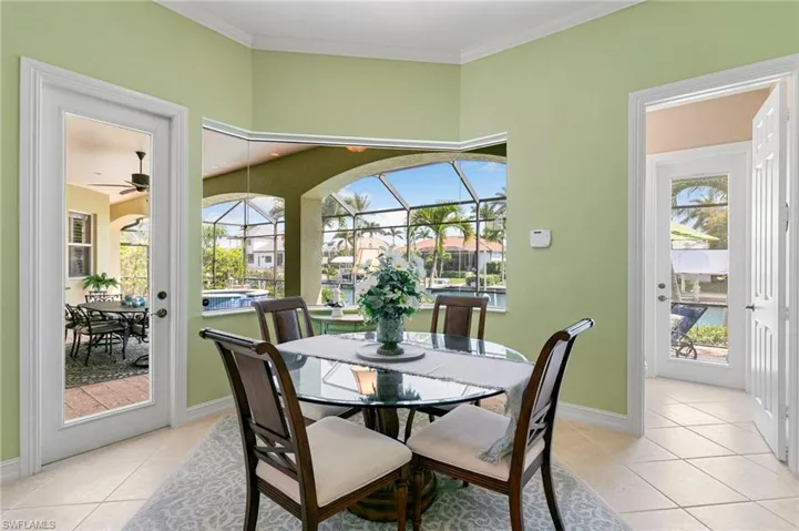 Dining room with plenty of natural light, baseboards, and light tile patterned floors