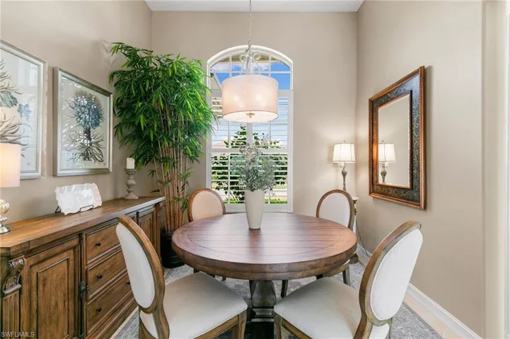 Dining space featuring baseboards and an inviting chandelier