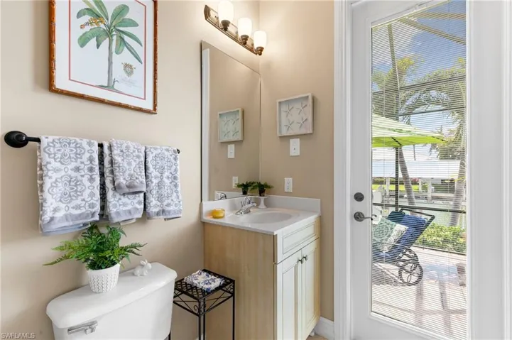 Bathroom with a healthy amount of sunlight, toilet, and vanity