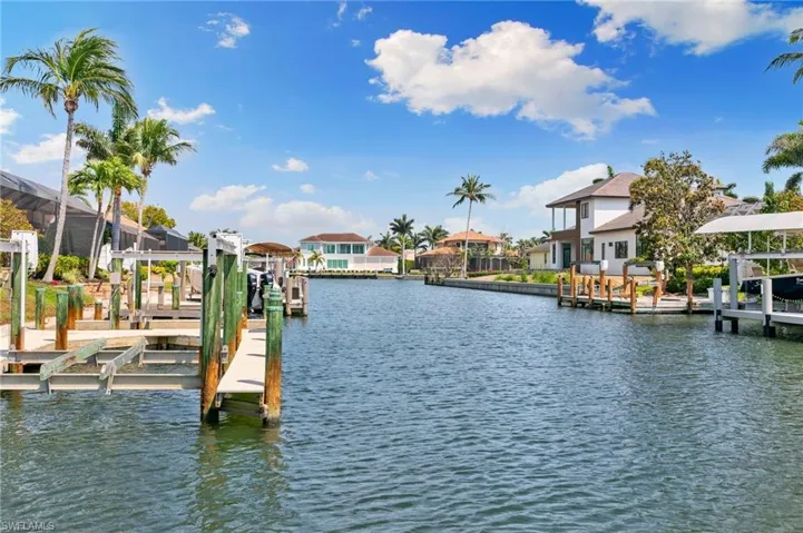 Dock area with a residential view, a water view, and boat lift