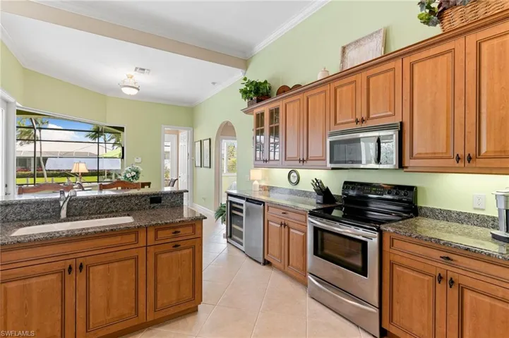 Kitchen with stainless steel appliances, a sink, and brown cabinets