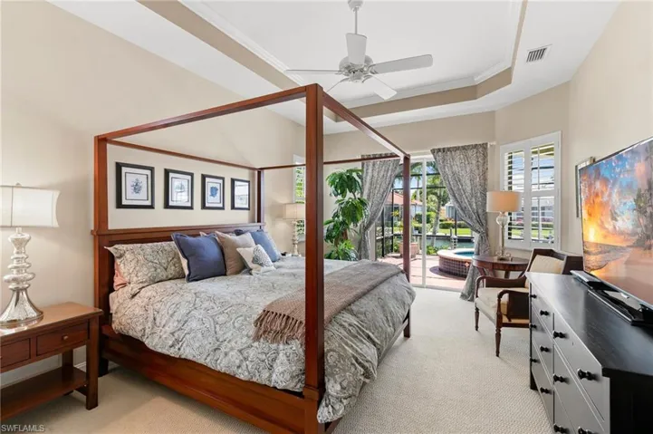 Bedroom featuring ornamental molding, light carpet, access to outside, and visible vents
