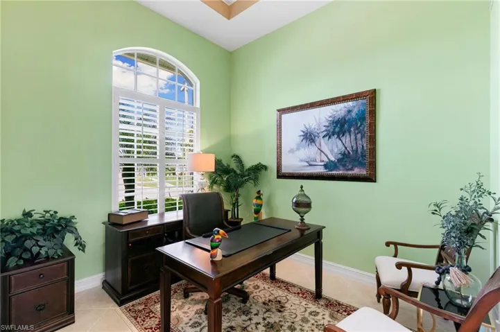 Office area with baseboards and light tile patterned floors