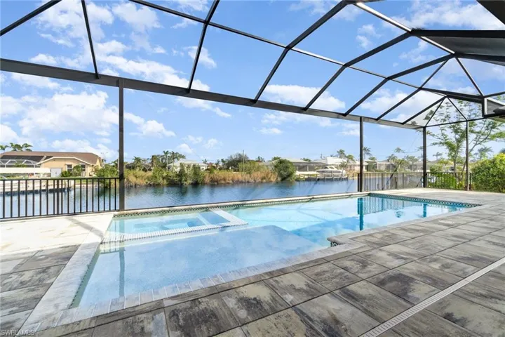 This beautiful pool has a flush spa, huge sunshelf, and a big picture window is in the screen enclosure for the great water views