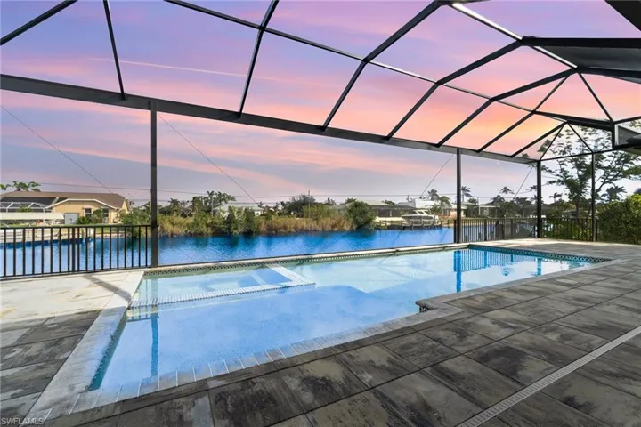View of canal through the picture window screen enclosure.