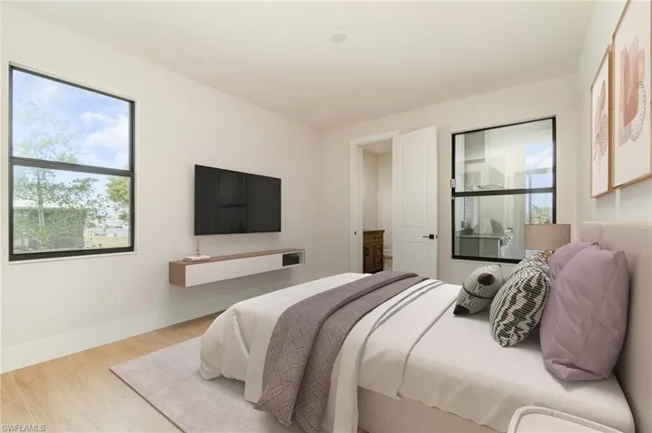2nd Suite guest bedroom with private bath/pool bath finished in wood plank tile flooring.