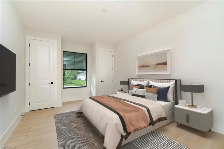 3rd Bedroom featuring two closets and wood plank tile flooring