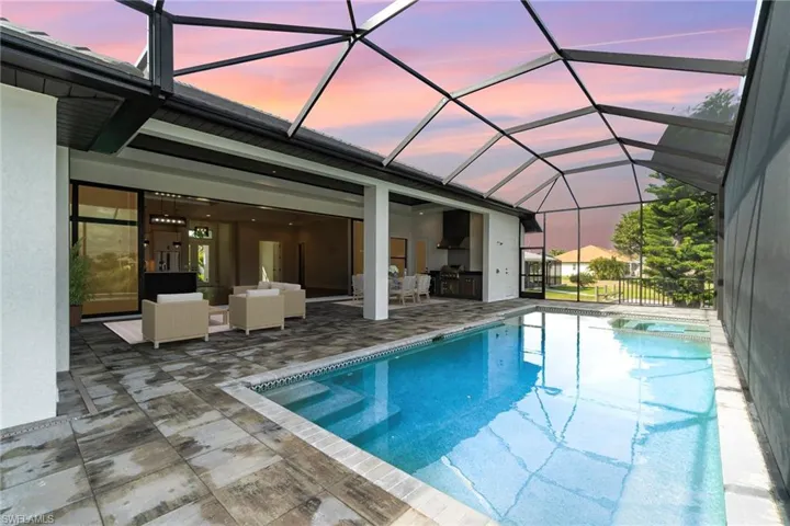 View of swimming pool with a sunroom, a lanai, a patio, an outdoor hangout area, and a pool with connected hot tub