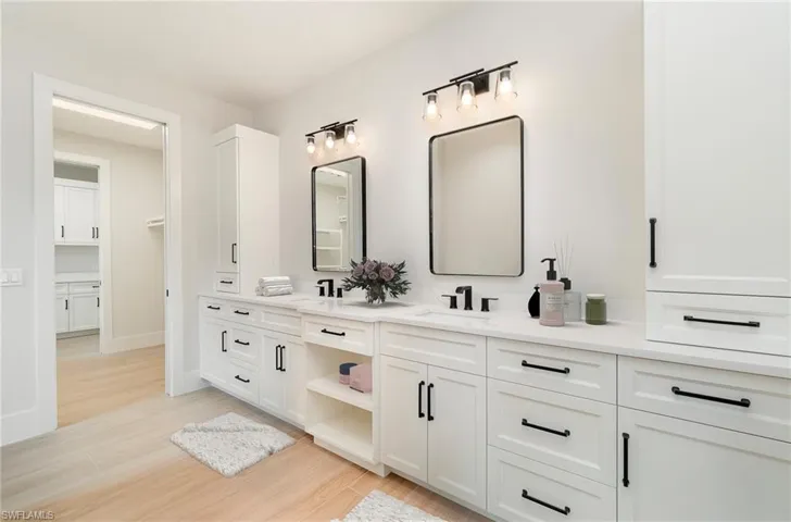 Master bathroom featuring huge double vanity and light wood plank tile flooring