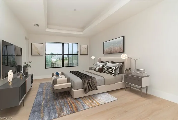Huge master bedroom with a tray ceiling and light wood plank tile floors