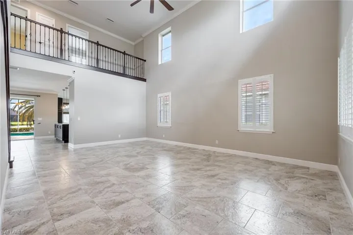 Wide Open living room with plenty of natural light, crown molding, and baseboards