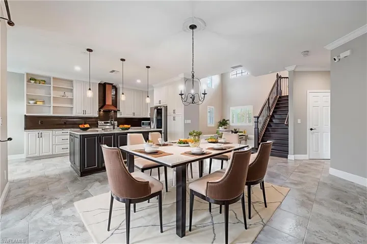 Dining space with a chandelier, stairway, crown molding, and recessed lighting Virtually Staged