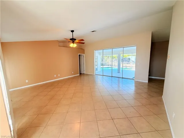 Spare room featuring ceiling fan and light tile patterned floors