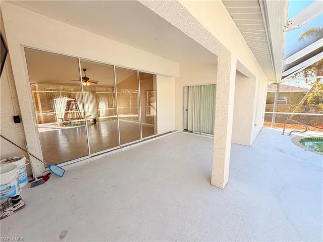 View of patio / terrace with a ceiling fan and glass enclosure