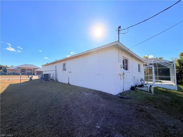 View of property exterior featuring a lanai, a sunroom, and stucco siding