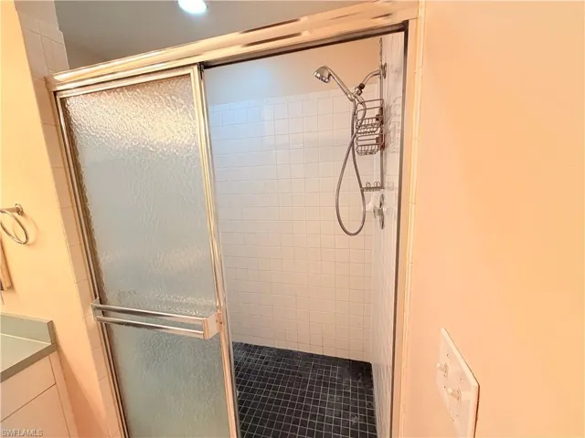 Full bathroom with a stall shower and vanity