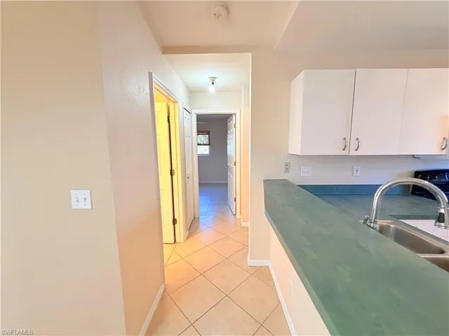 Kitchen with white cabinets and light tile patterned floors