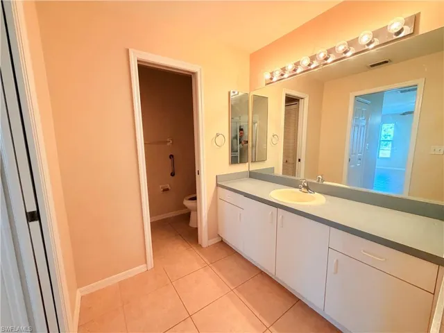 Full bath with vanity and light tile patterned flooring