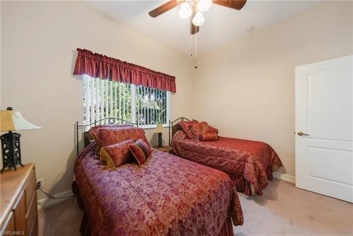 Carpeted bedroom with ceiling fan