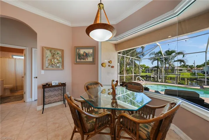 Dining room featuring ornamental molding and light tile patterned floors