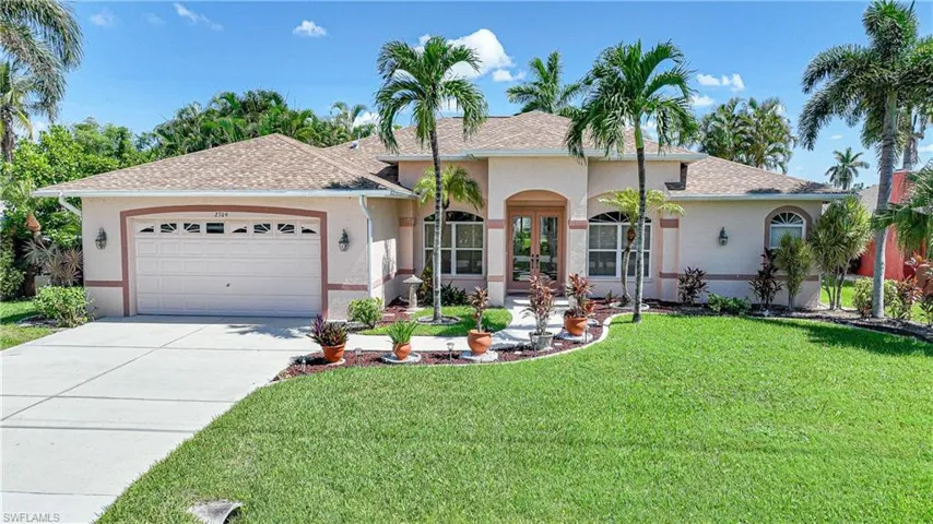 Ranch-style house with a garage and a front yard