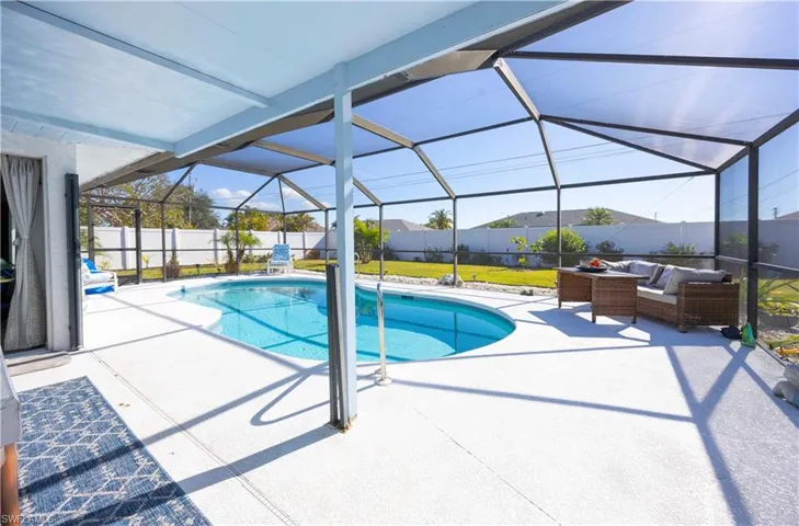 View of pool with a sunroom, a patio, glass enclosure, and a fenced backyard